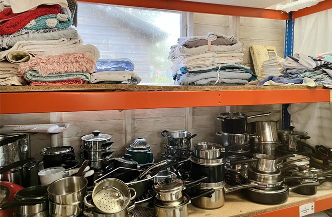 A shelving unit holds pots and pans