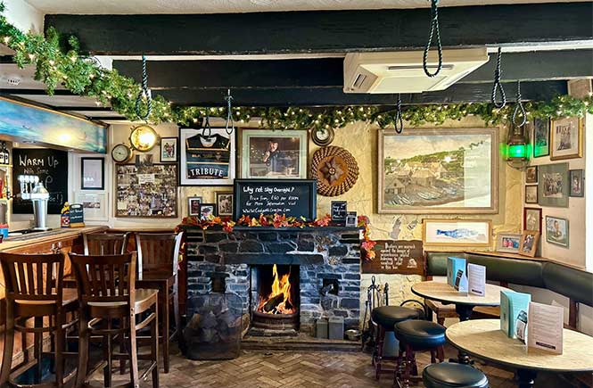 The cosy bar with a fireplace at Cadgwith Cove Inn in Cornwall