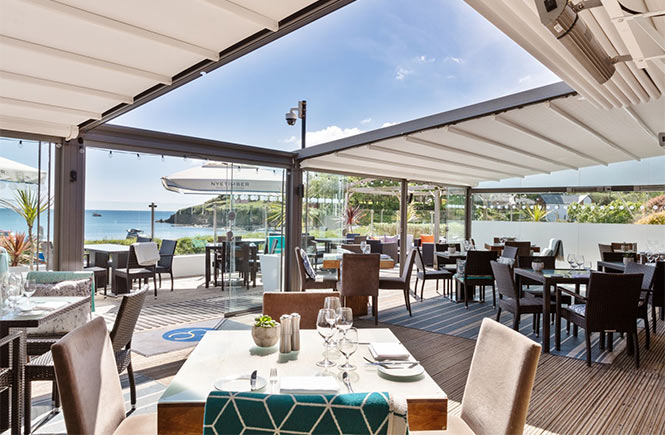 The beautiful, airy dining room with sea views at The Cove in Cornwall