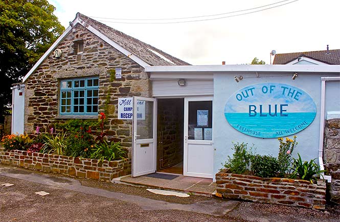 The stone and white exterior of Out of the Blue Freehouse in Porthleven
