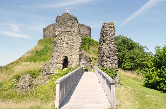 Looking up a wooden footbridge at the ancient ruins of Launceston Castle in Cornwall