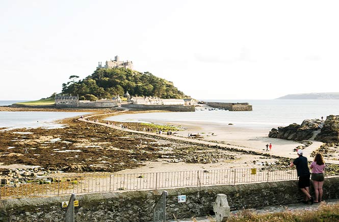 Two people looking out over St Michael's Mount in Cornwall