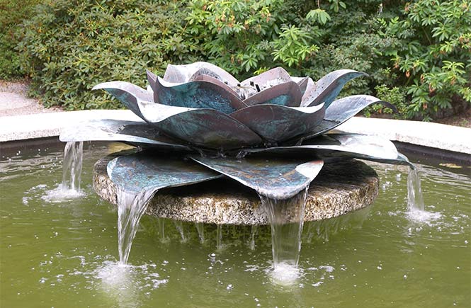 A bronze water fountain in the shape of a magnelia at Trewithen Gardens in Cornwall