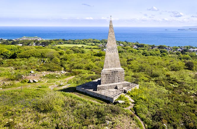 The towering stone Knill's Monument surrounded by moorland and fields along the coast from St Ives