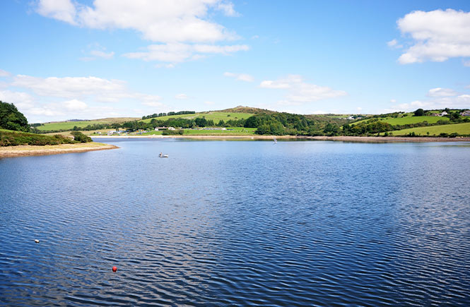 Looking out across the calm waters of Sibblyback Lake in Cornwall
