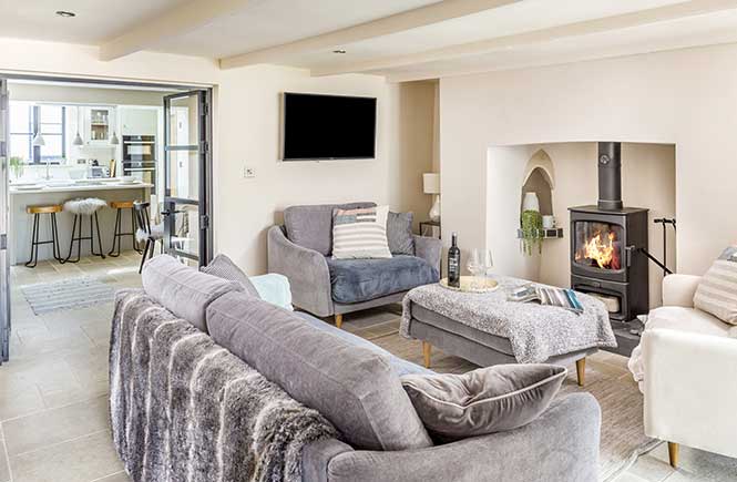 A charming lounge features a log burner