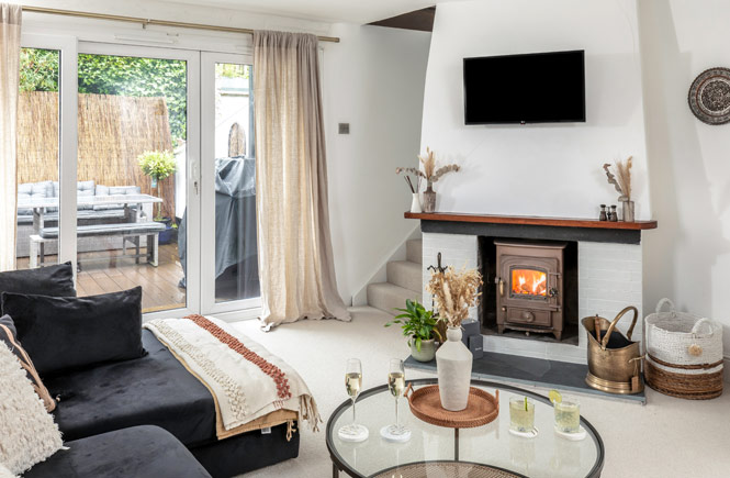 A cosy cottage living room and woodburner at 1 The Old Corn Store in St Agnes, Cornwall