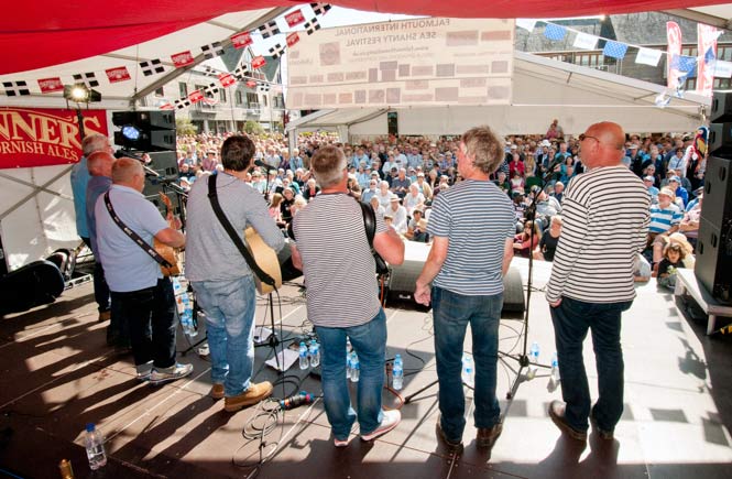 A group of singers on the main stage at the Falmouth International Sea Shanty Festival