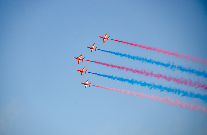 Five red arrows trailing colourful smoke in the skies over Falmouth Week