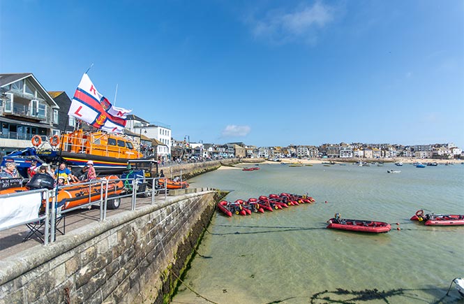 St Ives harbour on Lifeboat Day with the lifeboat pulled up the slipway and smaller lifeboats in the harbour