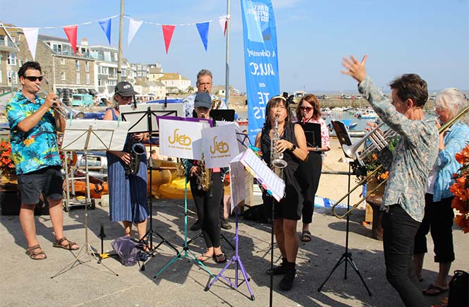 A band performing on the harbour front in St Ives during the St Ives September Festival