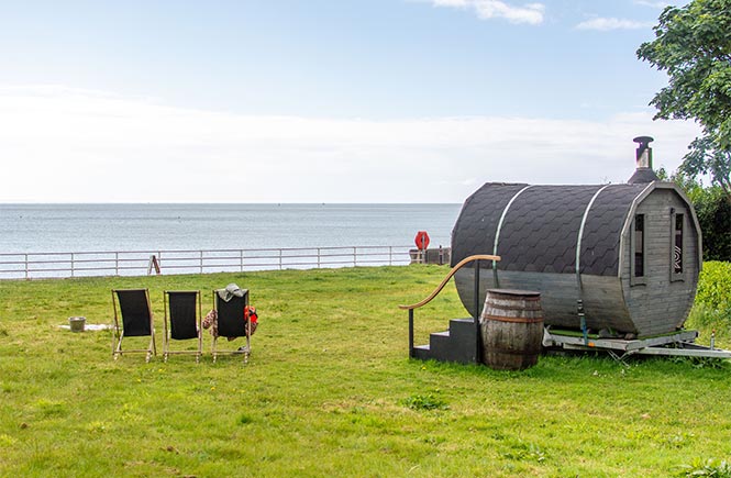 The wood-fired Rising Embers sauna on Newlyn Green by the sea in Cornwall