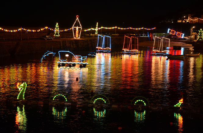 Christmas lights illuminating Mousehole harbour