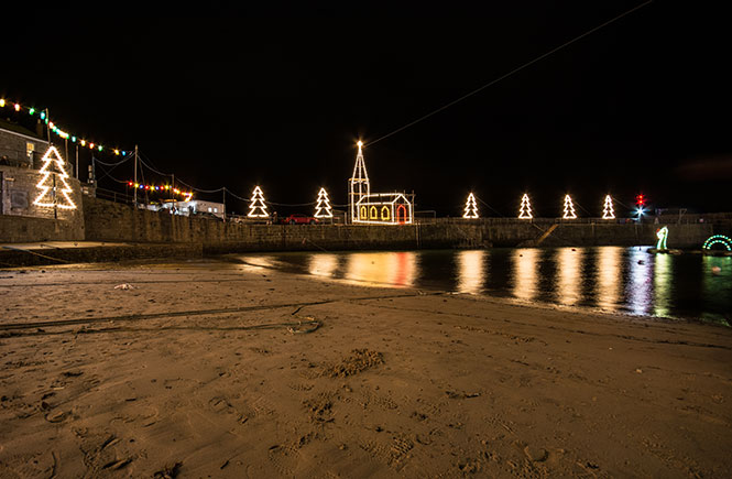 Looking over the beach at Mousehole at the Christmas lights above the harbour